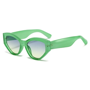 Retro cat-eye sunglasses with translucent green frame and blue-yellow gradient lenses