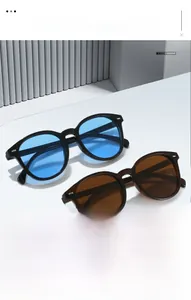 Detail showing vintage oval sunglasses with blue and brown lenses on a display stand