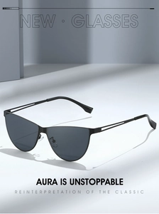 Detail showing sleek black cat-eye sunglasses with cutout metal temples and dark lenses