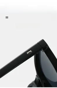 Macro view of black glossy frame with silver metal rivets and durable hinge detail