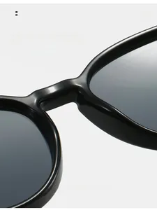 Detail of ergonomic integrated nose pads on black glossy oval sunglasses for comfort