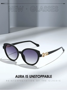 Detail of black frame sunglasses with purple gradient lenses and gold chain temple design