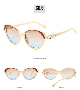 Detail view of cream cat-eye sunglasses with blue-pink gradient lenses and gold chain hinge