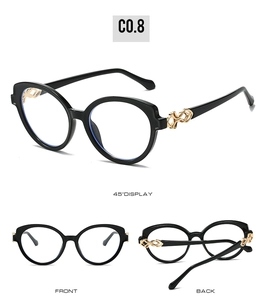 Detail view of oval cat-eye sunglasses with golden hollow temple decorations
