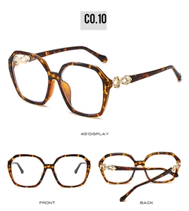 Detail view of tortoiseshell square sunglasses with gold infinity metal accents on temples
