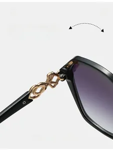 Close-up of durable golden metal chain hinge on stylish oversized square sunglasses