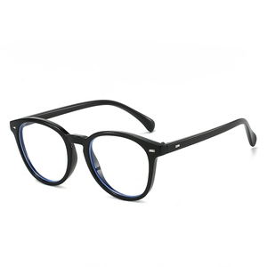 Classic round black sunglasses with metallic rivet accents and clear blue light lenses