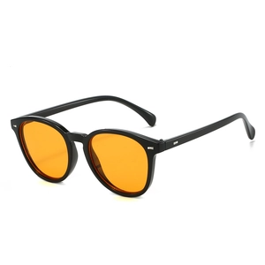 Oval black frame sunglasses with vibrant orange lenses and silver rivet detailing