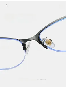 Macro view of adjustable transparent silicone nose pads on cat-eye metal glasses frame