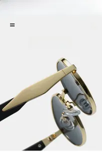 Detail of vintage metal flip-up sunglasses showing golden hinges and texture material