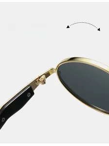 Macro shot of durable golden metal hinge on oval sunglasses with black temples