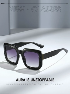 Detail view of bold square sunglasses with faceted black frames and gradient purple lenses