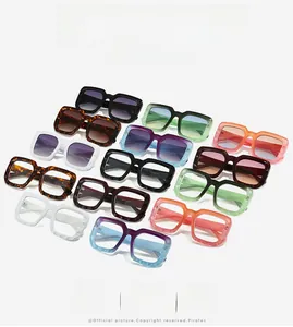 Flat lay of colorful oversized square sunglasses and thick frames in various vibrant colors