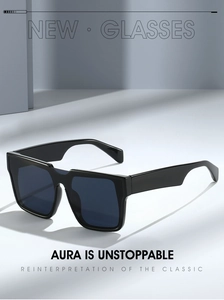 Detail of black oversized square sunglasses with dark grey lenses and wide temples