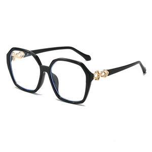 Fashionable oversized square black sunglasses with golden twisted metal hinge details