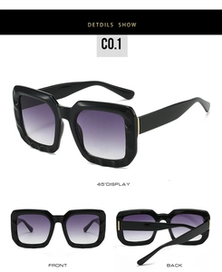Detail of square sunglasses with wavy textured frames and purple gradient lenses