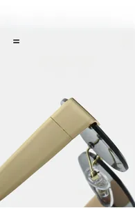 Macro detail of rimless sunglasses showing lightweight gold metal temples and nose pads