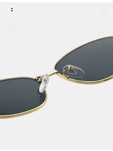Detail of comfortable silicone nose pads on gold metal cat-eye sunglasses for women