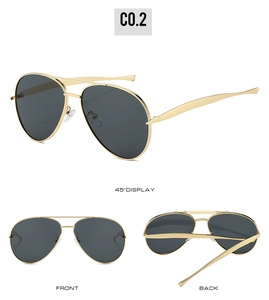 Detail view of gold metal aviator sunglasses with double bridge and dark grey lenses