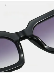 Detail of square sunglasses featuring black glossy frames and purple gradient lenses