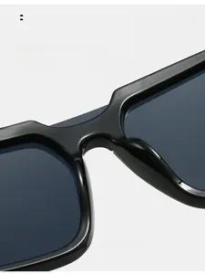 Close-up of comfortable integrated nose pads on black glossy oversized sunglasses
