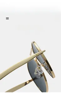Close-up of gold metal frame aviator sunglasses showing hinge detail and clear nose pads