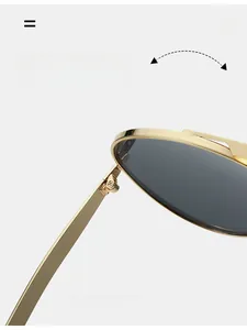 Detail of durable gold metal hinge on vintage aviator sunglasses with gray lenses