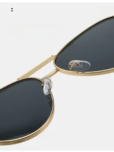 Detail view of comfortable clear silicone nose pads on gold metal aviator sunglasses