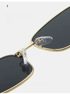 Detailed macro view of gold metal frame sunglasses with soft silicone nose pads