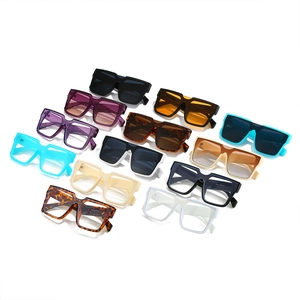 Multiple trendy oversized square sunglasses in diverse colors on a white background