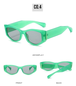 Détail de lunettes de soleil œil-de-chat vert translucide avec charnières en métal doré