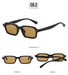 Detail view of black square frame sunglasses with amber lenses and silver rivet accents