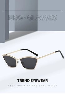 Detail of metal cat eye sunglasses with golden frames and dark lenses on geometric base