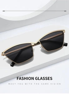 Detail of gold geometric cat eye sunglasses with black lenses on white blocks