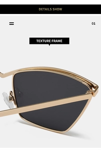 Macro detail of golden metal cat-eye sunglasses showing textured frame and silicone nose pads