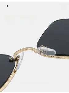 Macro detail of comfortable silicone nose pads on gold metal half-frame sunglasses