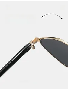 Detail of durable reinforced golden metal hinge and sleek black temple on sunglasses