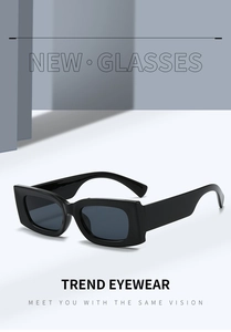 Detail view of bold square sunglasses with thick black frames and dark tinted lenses