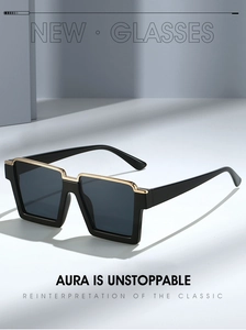 Close-up of black square sunglasses with a premium gold metal inlay on the upper frame