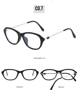 Detailed views of vintage oval black frames with gold metal temples and hinges