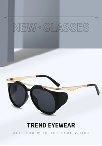 Detail of Y2K sunglasses with black wrap frames and gold metal temples in studio setting