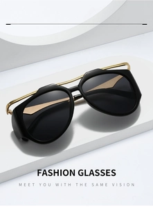 Detail view of black and gold Y2K sunglasses on a white minimalist display stand