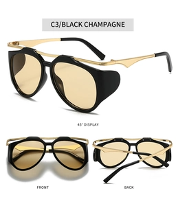 Detail view of Y2K sunglasses in Black Champagne with gold metal accents and side shields