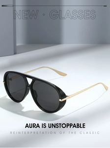 Close-up of stylish aviator sunglasses with black frames and gold metal temples