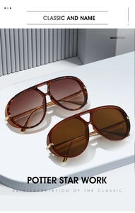 Close-up of tortoise shell aviator sunglasses with gradient brown lenses on a pedestal