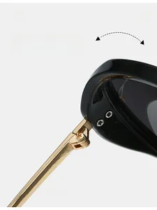 Macro shot of durable golden metal hinge connecting black frame of large sunglasses