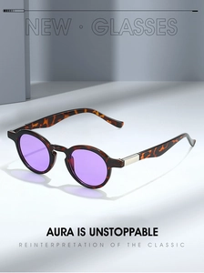 Detail view of tortoiseshell oval sunglasses with purple lenses and silver metal accents