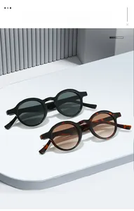 Detail view of retro oval sunglasses in classic black and vintage tortoise finishes