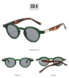 Detail view of oval green frames with tortoiseshell temples and metal hinges