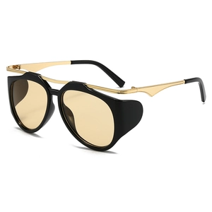 Y2K industrial style sunglasses with black gold frames and pale yellow lenses
